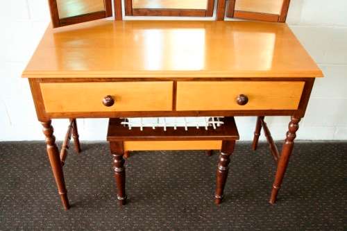 An exquisite two-drawer yellow wood & imbuia side-folding mirror dressing table with a riempie stool