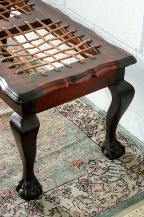 A stunning and well-made vintage solid imbuia ball & claw riempie foot stool with leather riempies