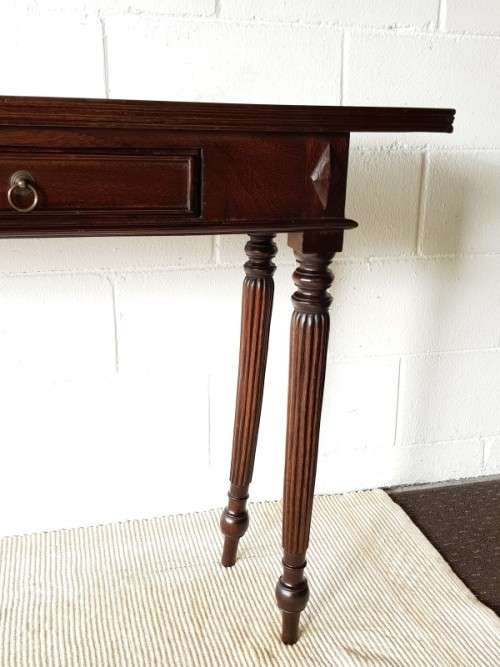 An amazing vintage two-drawer hallway table w fluted legs and lovely hand carved detailing