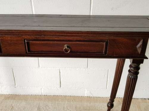 An amazing vintage two-drawer hallway table w fluted legs and lovely hand carved detailing