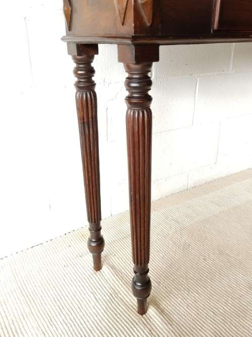 An amazing vintage two-drawer hallway table w fluted legs and lovely hand carved detailing