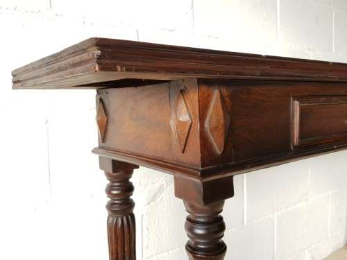 An amazing vintage two-drawer hallway table w fluted legs and lovely hand carved detailing
