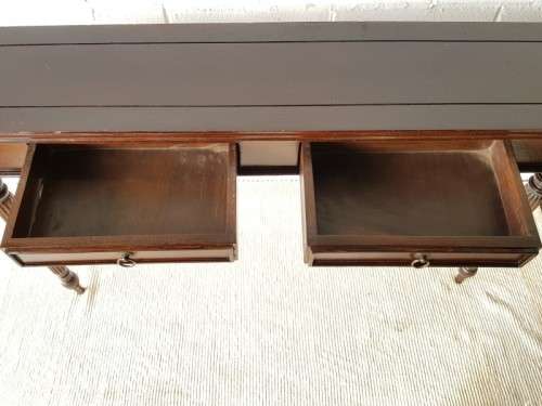 An amazing vintage two-drawer hallway table w fluted legs and lovely hand carved detailing