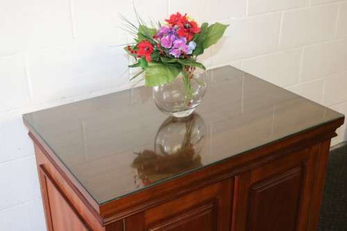 A wonderful Mahogany mini bar cabinet with shelves inside and a removable glass top on castors