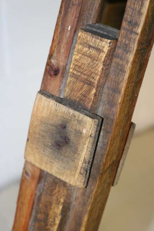 A fantastic antique metal and wood surveyor tripod in good condition for its impressive age