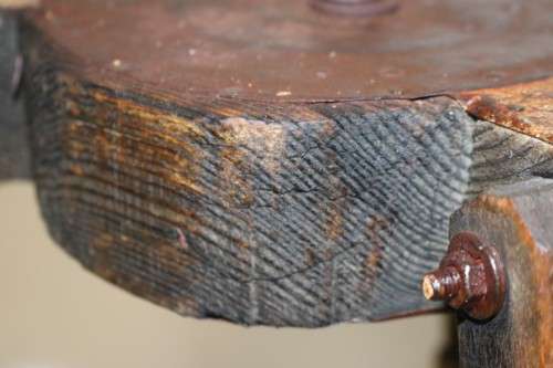 A fantastic antique metal and wood surveyor tripod in good condition for its impressive age