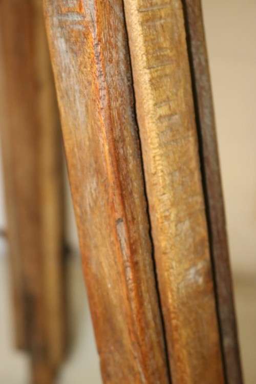 A fantastic antique metal and wood surveyor tripod in good condition for its impressive age