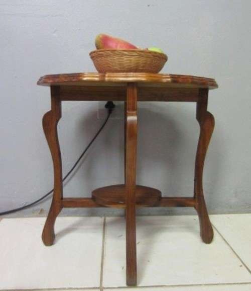 A gorgeous and stylish vintage solid teak oval occasional coffee table with scalloped style edges