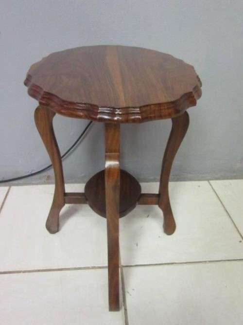 A gorgeous and stylish vintage solid teak oval occasional coffee table with scalloped style edges