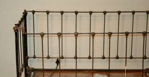 A stunning & rare antique (late 1800's) wrought iron baby's cot w/ dropside on its original castors