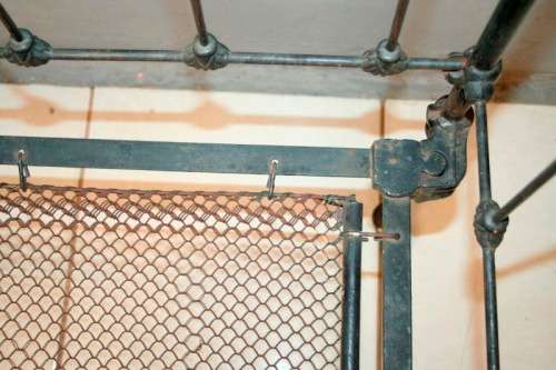 A stunning & rare antique (late 1800's) wrought iron baby's cot w/ dropside on its original castors