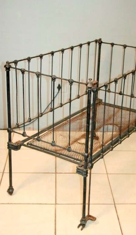 A stunning & rare antique (late 1800's) wrought iron baby's cot w/ dropside on its original castors