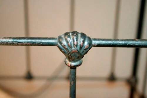 A stunning & rare antique (late 1800's) wrought iron baby's cot w/ dropside on its original castors