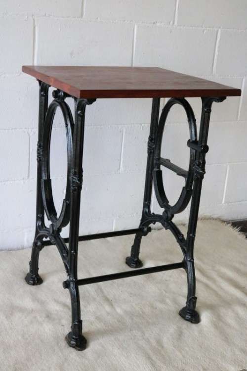 An amazing vintage cast iron sewing table with a wooden top - well made and very heavy!
