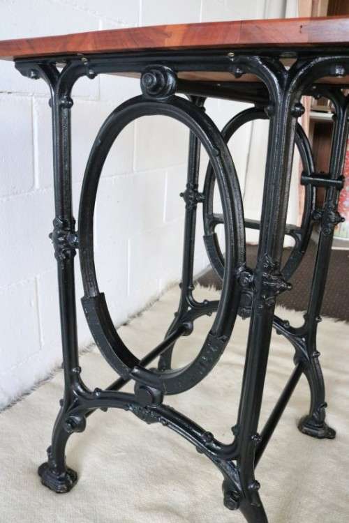 An amazing vintage cast iron sewing table with a wooden top - well made and very heavy!