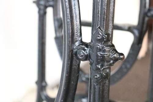 An amazing vintage cast iron sewing table with a wooden top - well made and very heavy!