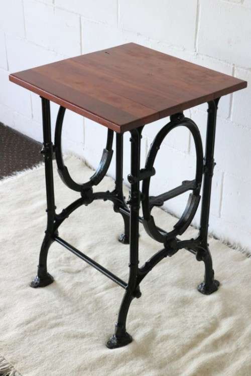 An amazing vintage cast iron sewing table with a wooden top - well made and very heavy!