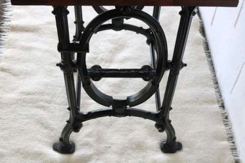 An amazing vintage cast iron sewing table with a wooden top - well made and very heavy!