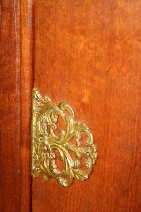 A stunning and beautifully made curved glass Teak show cabinet with solid brass embellishments