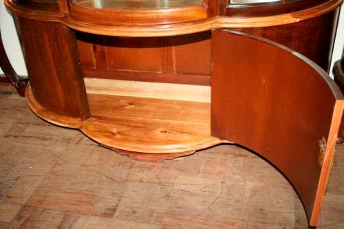 A stunning and beautifully made curved glass Teak show cabinet with solid brass embellishments