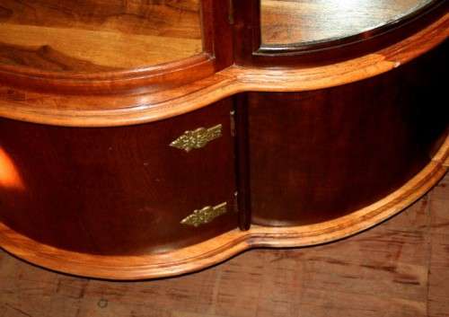 A stunning and beautifully made curved glass Teak show cabinet with solid brass embellishments