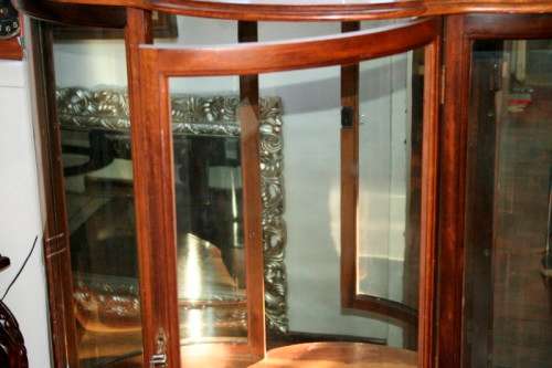 A stunning and beautifully made curved glass Teak show cabinet with solid brass embellishments