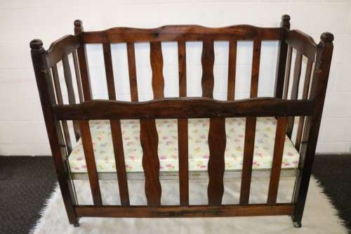 An awesome vintage solid Imbuia baby's cot on its original castors - perfect for nursery