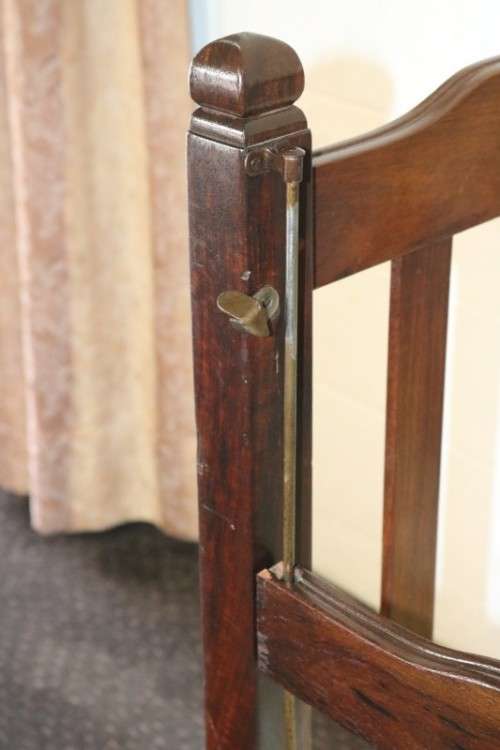 An awesome vintage solid Imbuia baby's cot on its original castors - perfect for nursery