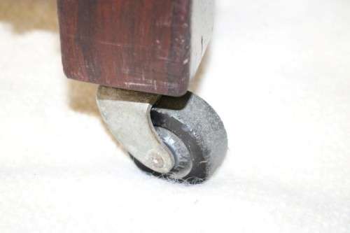 An awesome vintage solid Imbuia baby's cot on its original castors - perfect for nursery