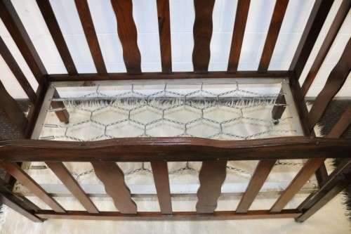 An awesome vintage solid Imbuia baby's cot on its original castors - perfect for nursery