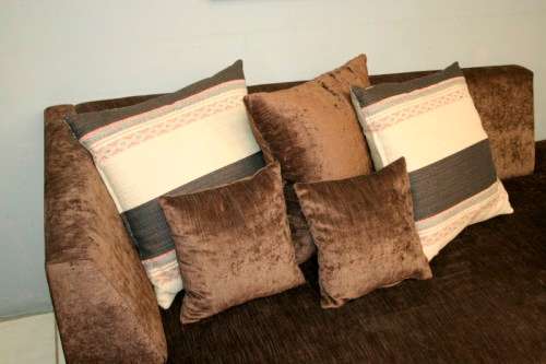 A superb modern (X-large) chocolate brown fabric couch w/ stunning cushions in exquisite condition