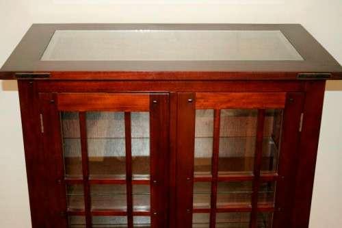An incredibly well made solid Indonesian teak cabinet with glass shelves and beautiful slatted doors