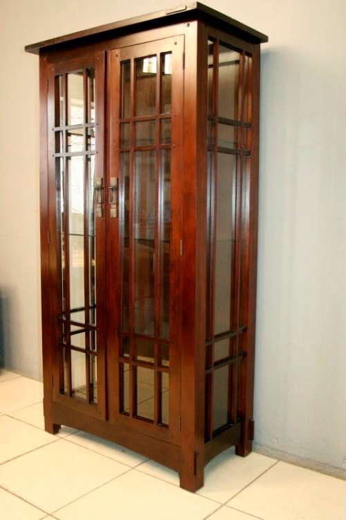 An incredibly well made solid Indonesian teak cabinet with glass shelves and beautiful slatted doors