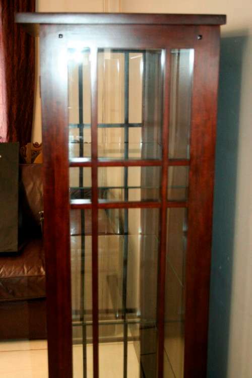 An incredibly well made solid Indonesian teak cabinet with glass shelves and beautiful slatted doors