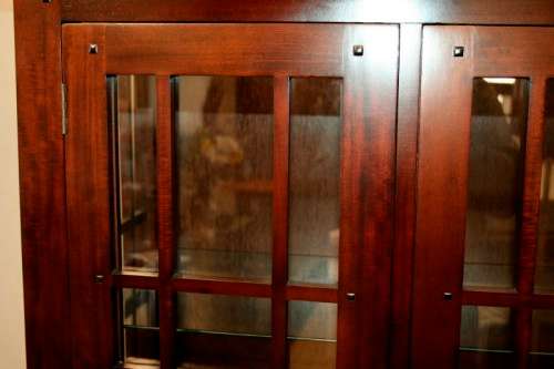 An incredibly well made solid Indonesian teak cabinet with glass shelves and beautiful slatted doors