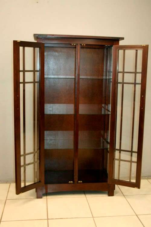 An incredibly well made solid Indonesian teak cabinet with glass shelves and beautiful slatted doors