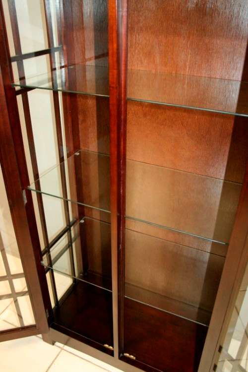 An incredibly well made solid Indonesian teak cabinet with glass shelves and beautiful slatted doors