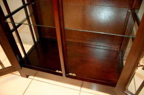 An incredibly well made solid Indonesian teak cabinet with glass shelves and beautiful slatted doors