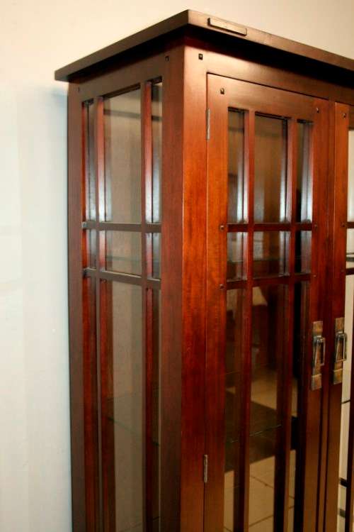 An incredibly well made solid Indonesian teak cabinet with glass shelves and beautiful slatted doors