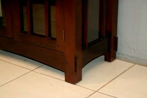 An incredibly well made solid Indonesian teak cabinet with glass shelves and beautiful slatted doors