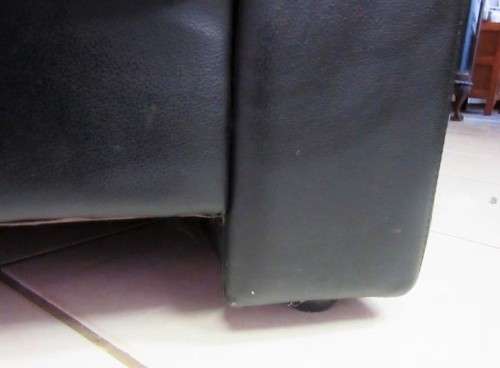 A beautiful well made black genuine leather single sofa with padded armrests & comfortable seating!!