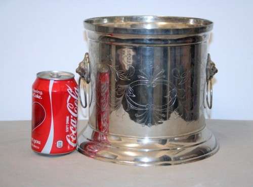 A stunning silver plated wine cooler with beautiful engraved detailing and lion-head ring handles