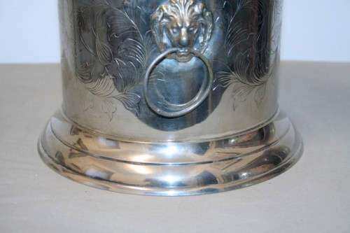 A stunning silver plated wine cooler with beautiful engraved detailing and lion-head ring handles
