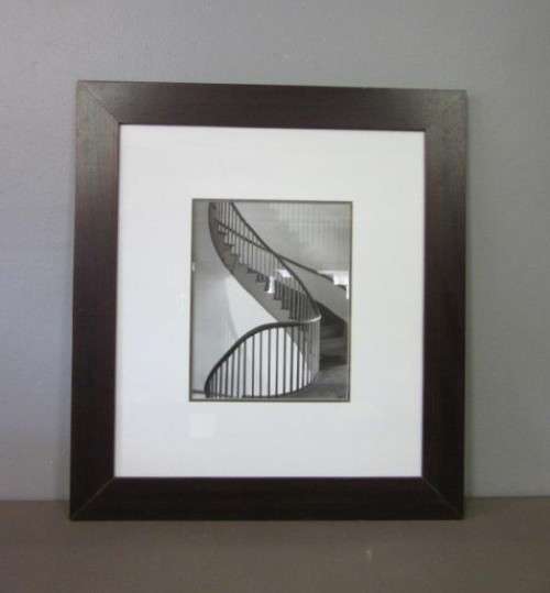**RS17** A (large) black and white photograph of a spiral staircase in a broad-border frame