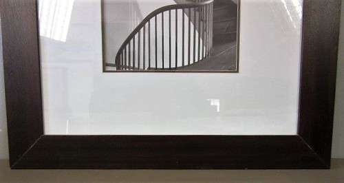 **RS17** A (large) black and white photograph of a spiral staircase in a broad-border frame