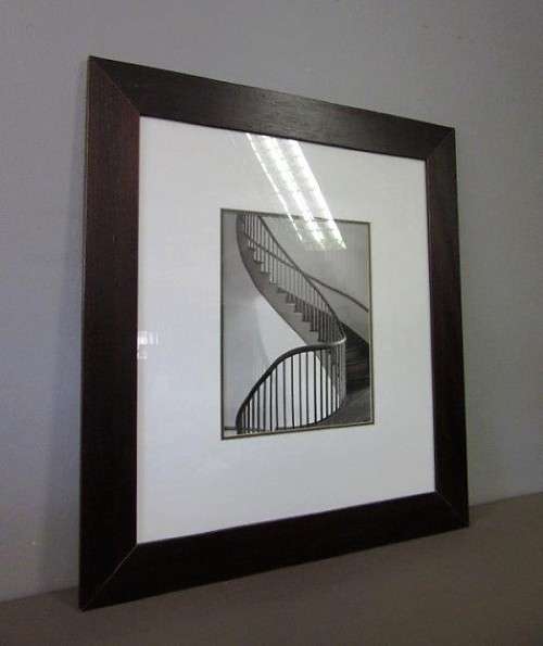 **RS17** A (large) black and white photograph of a spiral staircase in a broad-border frame
