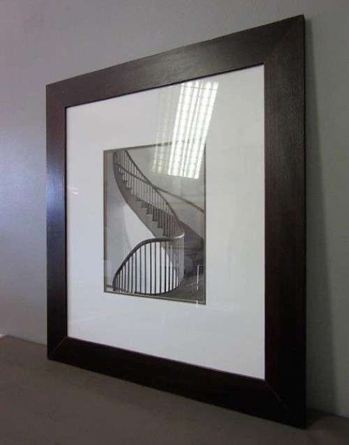 **RS17** A (large) black and white photograph of a spiral staircase in a broad-border frame