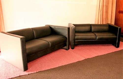 An awesome and stylish black bonded leather 2-seater "Tuxedo" couch in great condition