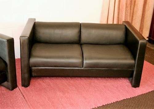 An awesome and stylish black bonded leather 2-seater "Tuxedo" couch in great condition