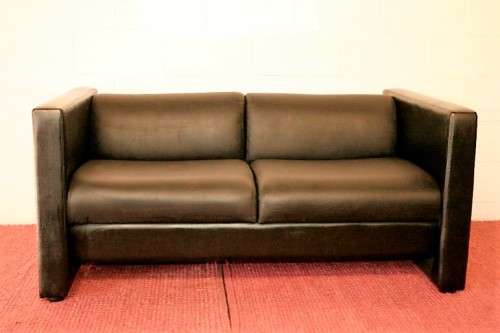An awesome and stylish black bonded leather 2-seater "Tuxedo" couch in great condition